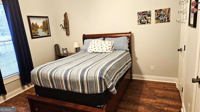 bedroom featuring wood finished floors and baseboards