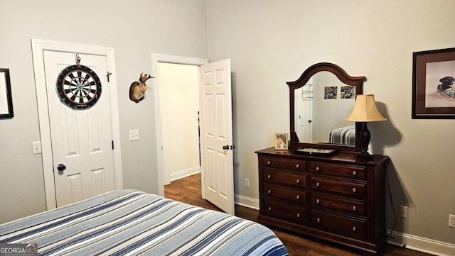 bedroom featuring dark wood-style floors and baseboards