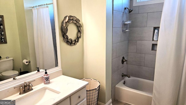 bathroom featuring toilet, shower / bath combo with shower curtain, and vanity