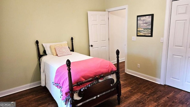 bedroom with baseboards and wood finished floors