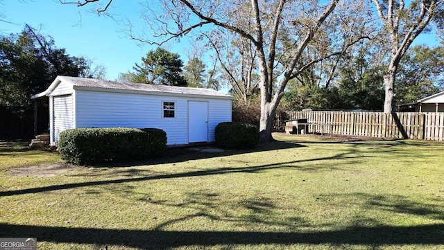 view of yard with an outbuilding and fence