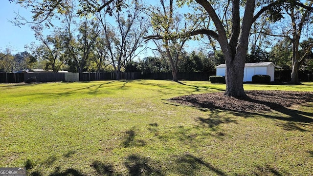 view of yard featuring an outbuilding and fence