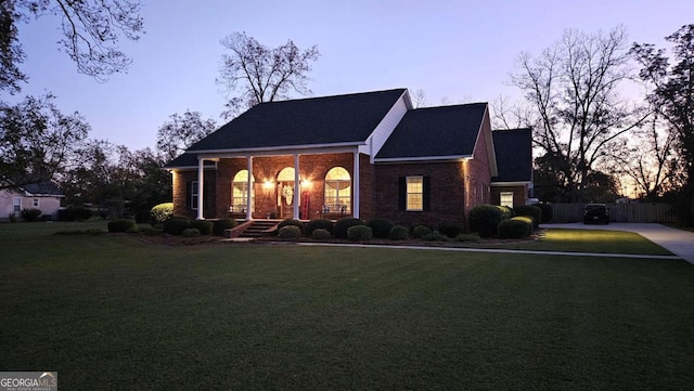 view of front of house with brick siding and a front lawn