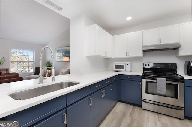 kitchen with blue cabinets, sink, white cabinetry, stainless steel electric range oven, and light hardwood / wood-style flooring