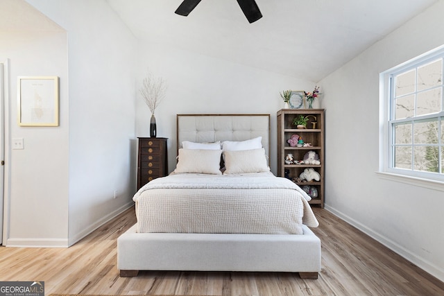 bedroom featuring lofted ceiling, light hardwood / wood-style floors, and ceiling fan