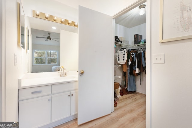 bathroom featuring vanity, hardwood / wood-style flooring, and ceiling fan