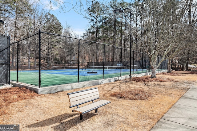 view of home's community with tennis court