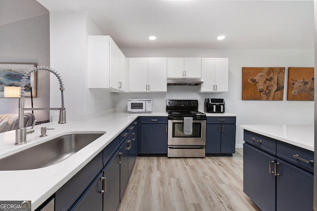 kitchen with blue cabinets, sink, white cabinets, electric range, and light hardwood / wood-style flooring