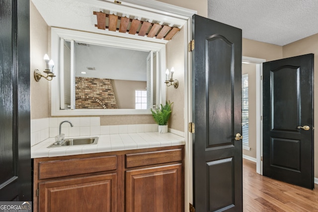 bathroom with vanity, hardwood / wood-style flooring, and a textured ceiling