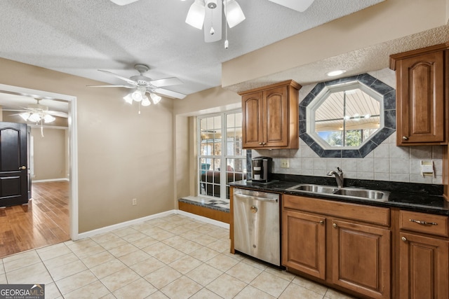 kitchen featuring dishwasher, sink, a wealth of natural light, and ceiling fan