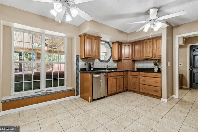 kitchen featuring sink, dishwasher, ceiling fan, light tile patterned flooring, and decorative backsplash