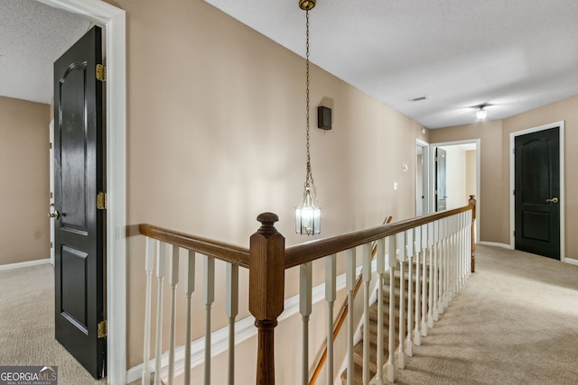 corridor featuring light colored carpet