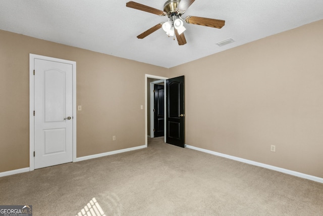 unfurnished bedroom with light colored carpet and ceiling fan