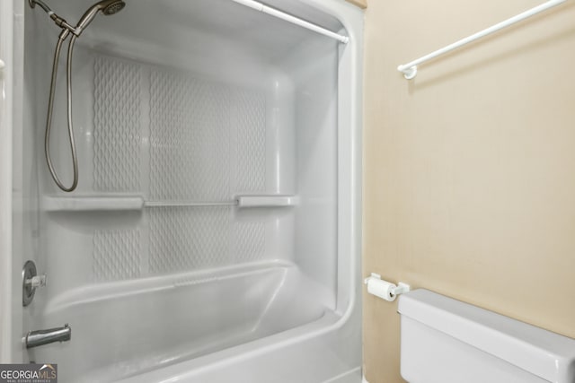 bathroom featuring washtub / shower combination and toilet