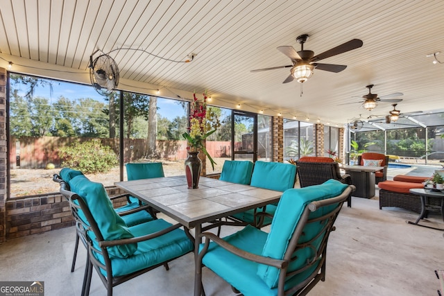 view of patio with a lanai, an outdoor hangout area, and ceiling fan