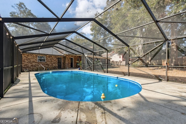 view of pool featuring a lanai and a patio