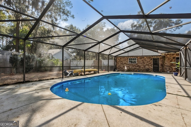 view of swimming pool featuring a lanai and a patio area