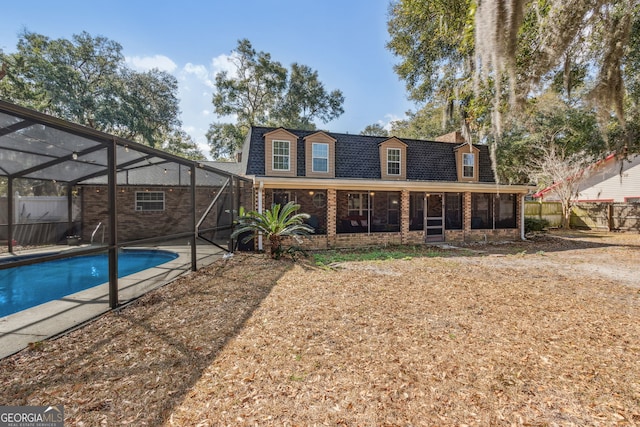 back of property with a lanai