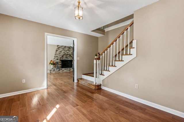 foyer entrance featuring hardwood / wood-style floors and a fireplace