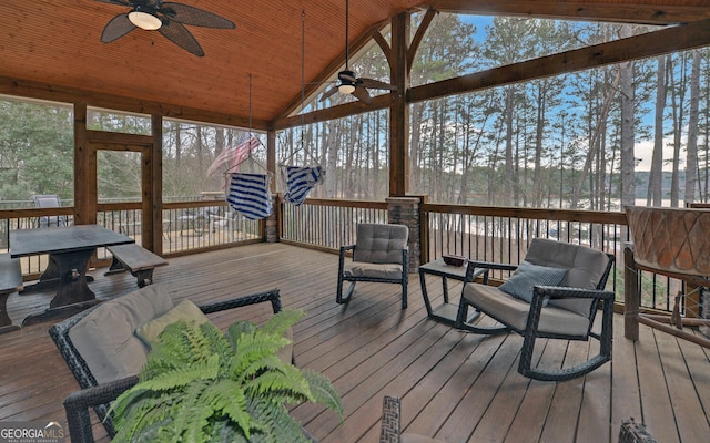 sunroom / solarium with vaulted ceiling, wooden ceiling, and ceiling fan