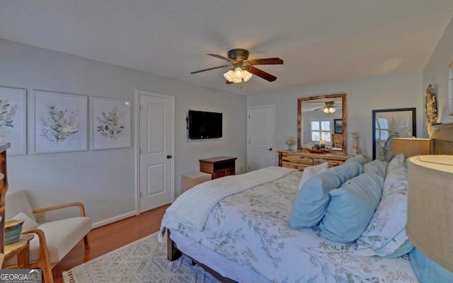 bedroom with light hardwood / wood-style floors and ceiling fan