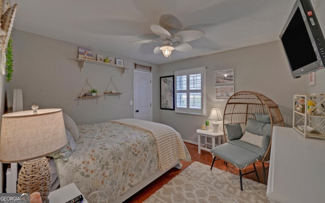 bedroom featuring hardwood / wood-style floors and ceiling fan