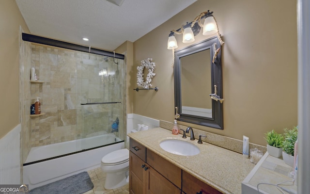 full bathroom with toilet, bath / shower combo with glass door, a textured ceiling, vanity, and tile patterned flooring