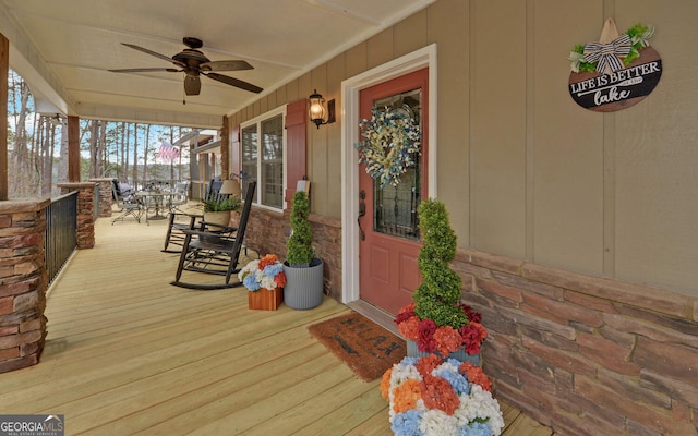 doorway to property with ceiling fan and a porch