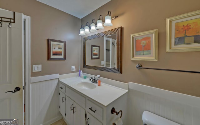 bathroom featuring vanity and toilet