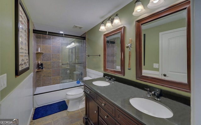 full bathroom with vanity, toilet, and combined bath / shower with glass door