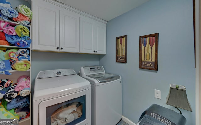 washroom featuring cabinets and independent washer and dryer