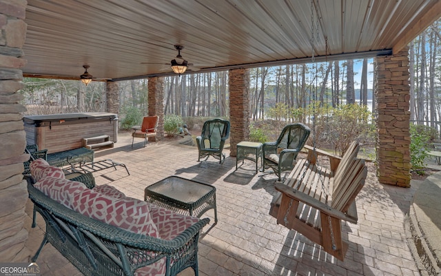 view of patio featuring an outdoor living space, a hot tub, and ceiling fan