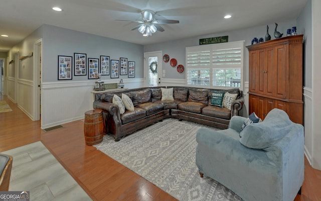 living room featuring ceiling fan and light hardwood / wood-style floors