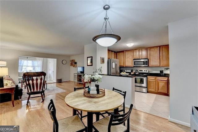 dining area with light wood-type flooring