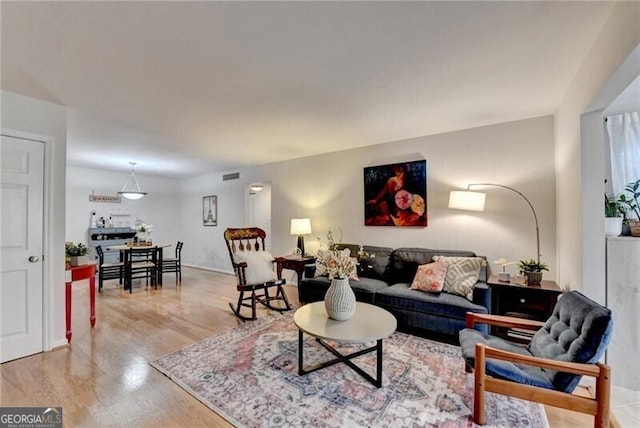 living room with light hardwood / wood-style flooring