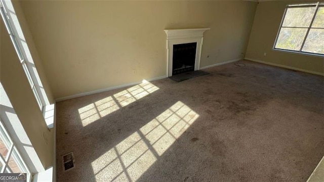 unfurnished living room with carpet flooring