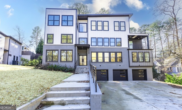 contemporary home featuring a garage and a front yard