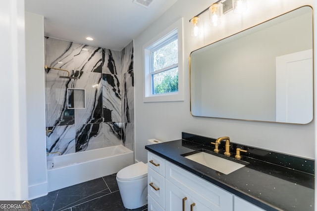 full bathroom featuring tiled shower / bath, vanity, and toilet