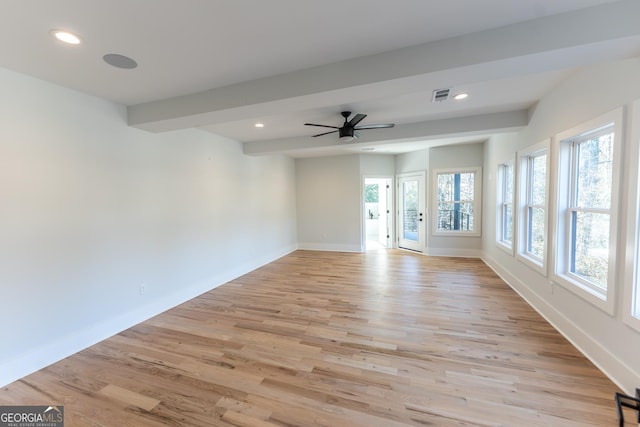 spare room with beamed ceiling, ceiling fan, and light wood-type flooring