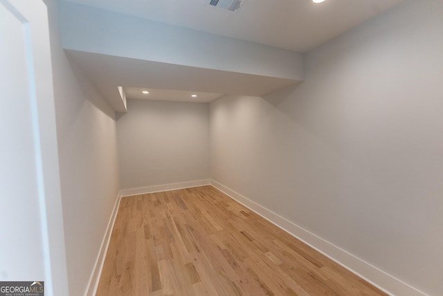 basement with light hardwood / wood-style floors