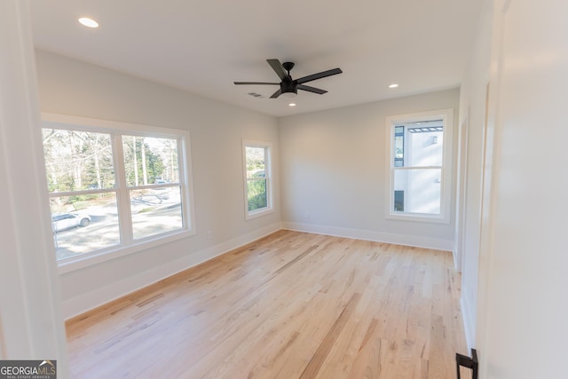 empty room featuring ceiling fan and light hardwood / wood-style floors