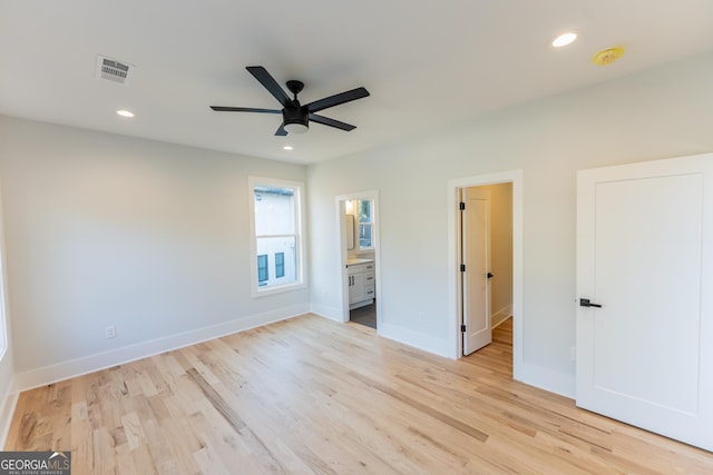 unfurnished bedroom with ceiling fan, connected bathroom, and light hardwood / wood-style flooring