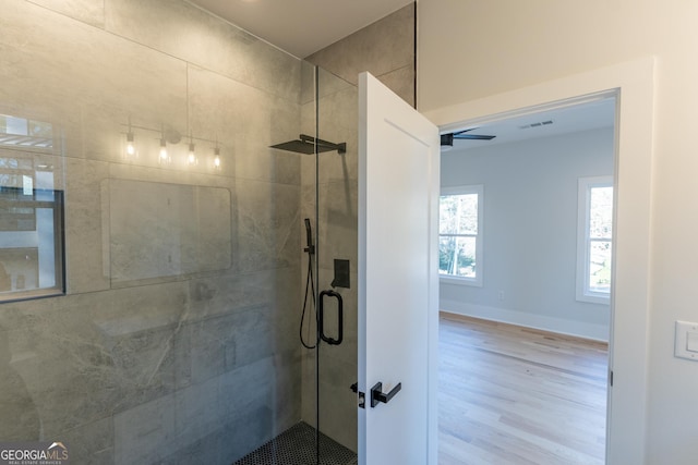 bathroom featuring walk in shower and hardwood / wood-style floors