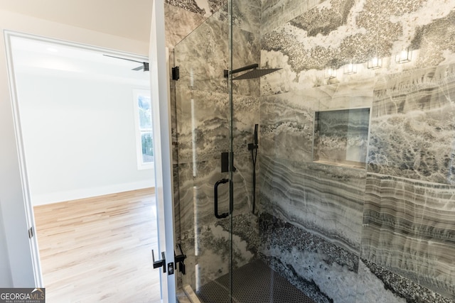 bathroom featuring hardwood / wood-style flooring and an enclosed shower