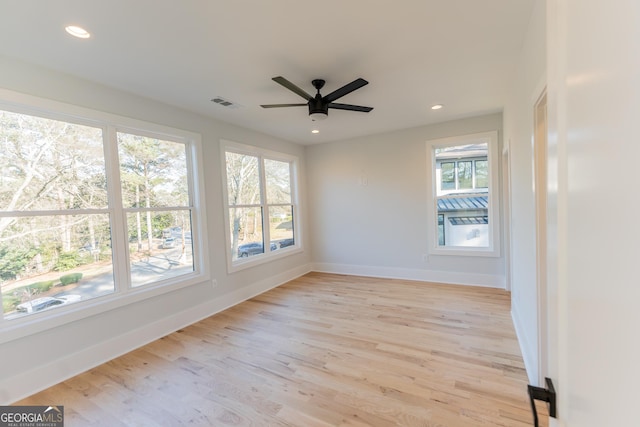 spare room with ceiling fan and light hardwood / wood-style floors