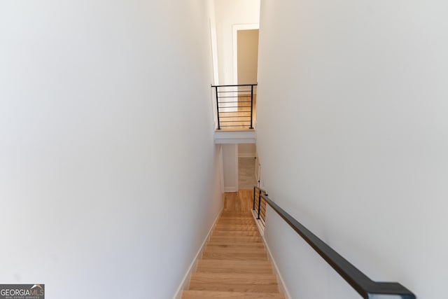 stairs featuring hardwood / wood-style floors