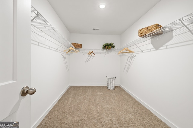 walk in closet with light carpet and visible vents