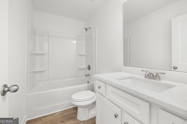 bathroom with toilet, vanity, bathing tub / shower combination, and wood finished floors