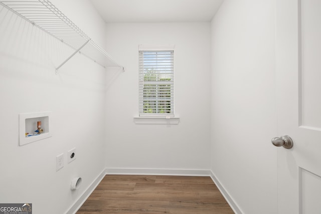 laundry area with wood finished floors, baseboards, hookup for an electric dryer, laundry area, and washer hookup