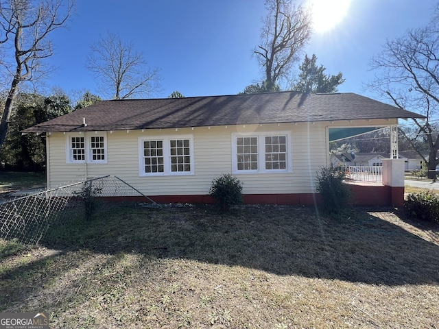 back of house featuring a yard